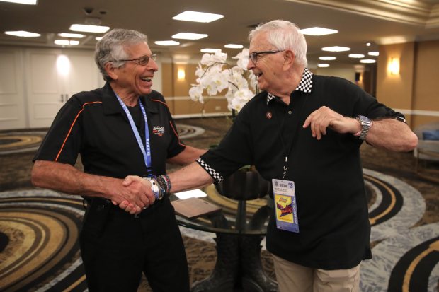 Jim Michaelian, president and CEO of the Grand Prix Association, left, congratulates columnist Rich Archbold as the recipient of this year's Allen Wolfe Spirit Award on Saturday, Apr. 20, 2024, in the Grand Prix of Long Beach media center. (Photo by Howard Freshman, Contributing Photographer)