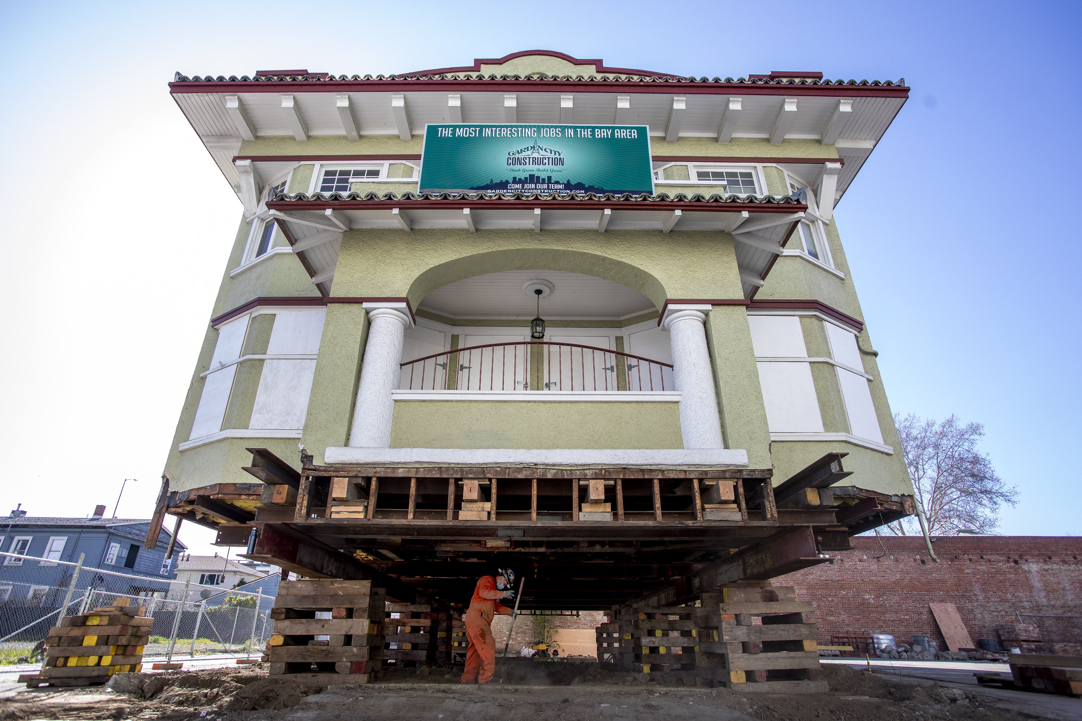 A crew member from Kelly Brothers House Movers cleans up...