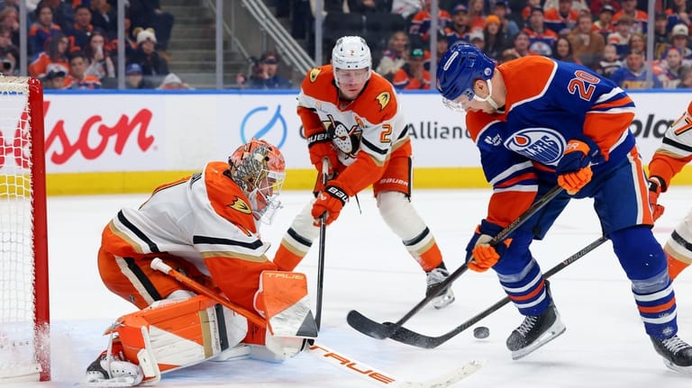 Anaheim Ducks goalie Lukas Dostal (1), Jackson LaCombe (2) and...
