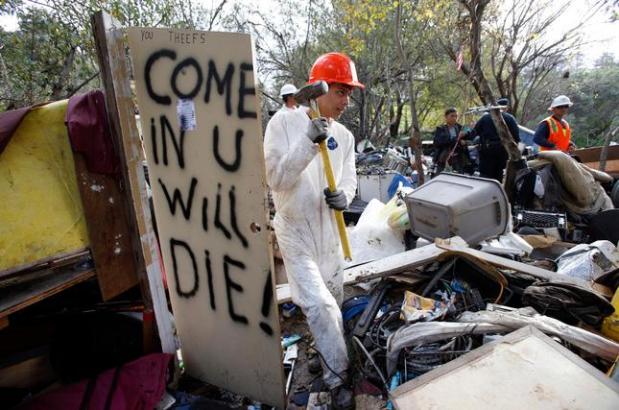 Demolition crews tear down The Jungle homeless camp along Story Road in San Jose, Calif., after the city closed it Thursday, Dec. 4, 2014. (Karl Mondon/Bay Area News Group)
