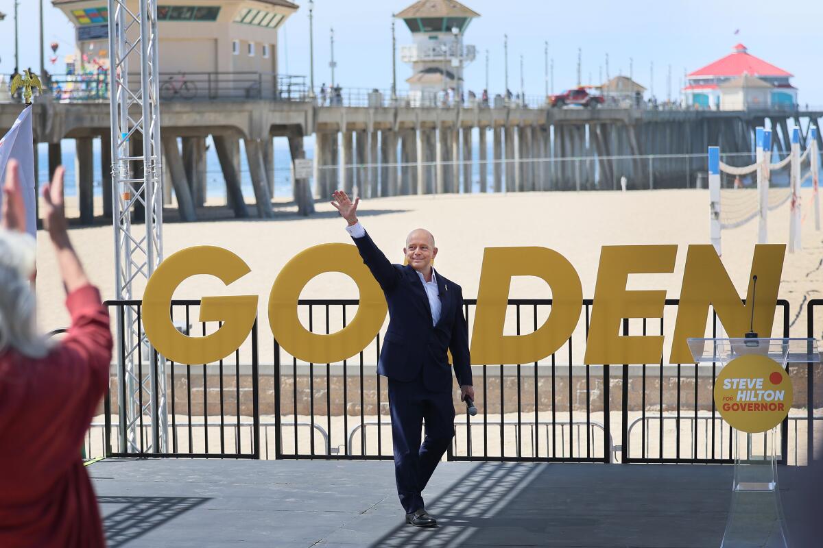 Gubernatorial hopeful Steve Hilton waves to a crowd at the Pier Plaza in Huntington Beach.