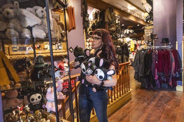 Teri Burge, a senior buyer at Evangeline’s Costume Mansion, restocks merchandise on Tuesday as the landmark Old Sacramento store announced its reopening date after a June fire.