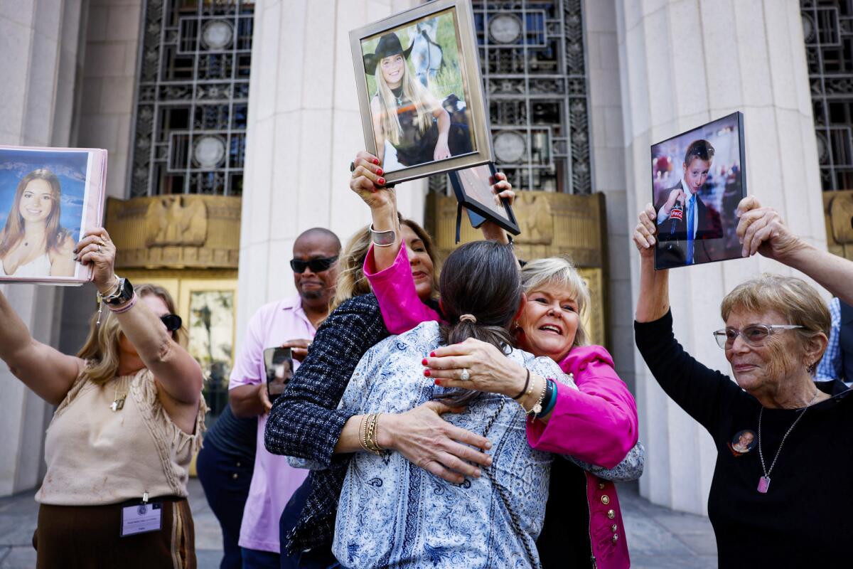  Juliana Arnold, Mary Rodee and Lori Schott embrace.