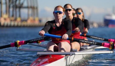 USC Women's Rowers high-five on the water