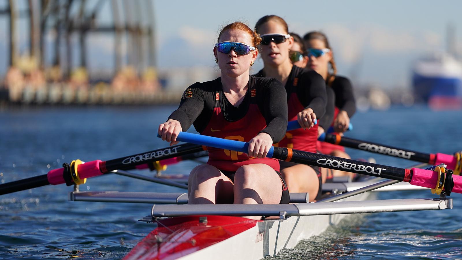 USC Women's Rowers high-five on the water