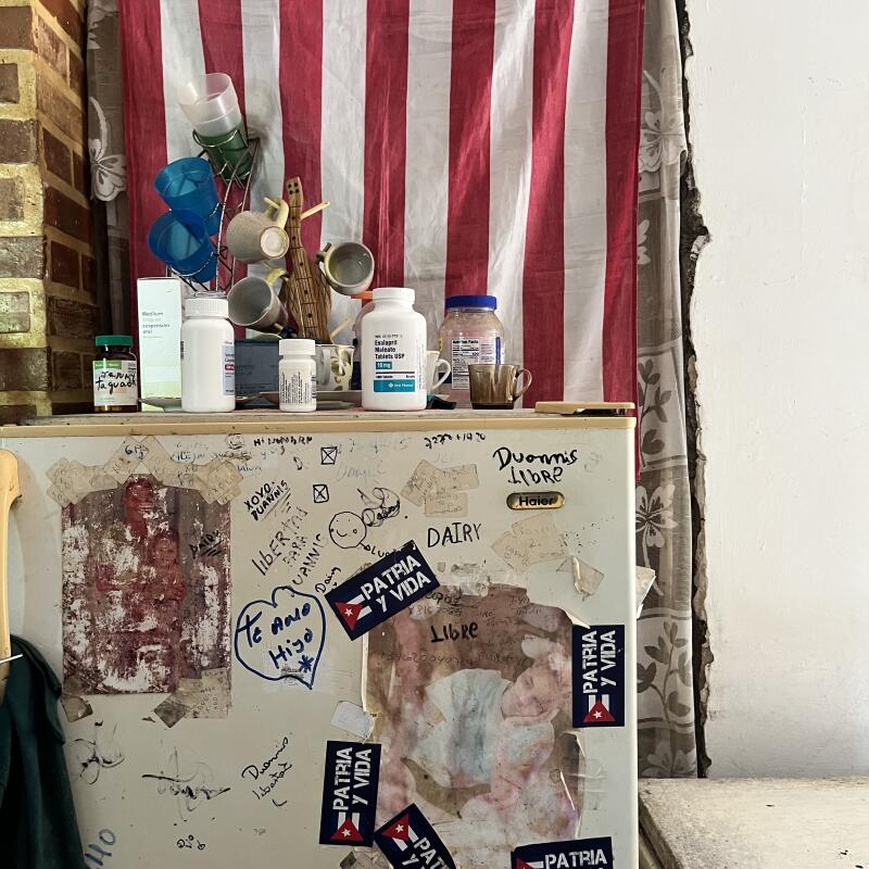 the side of a refrigerator with stickers and an American flag