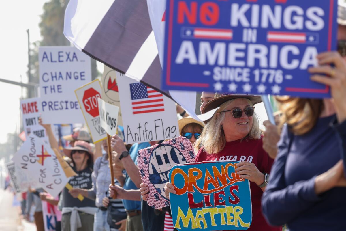People gather at a No Kings protest along Pacific Coast Highway in Huntington Beach