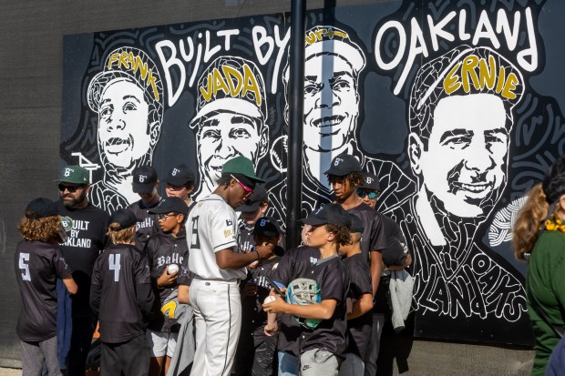 An Oakland Baller signs autographs for young fans at their home opener, Tuesday, May 20, 2025, at Raimondi Park in Oakland, Calif. (Karl Mondon/Bay Area News Group)
