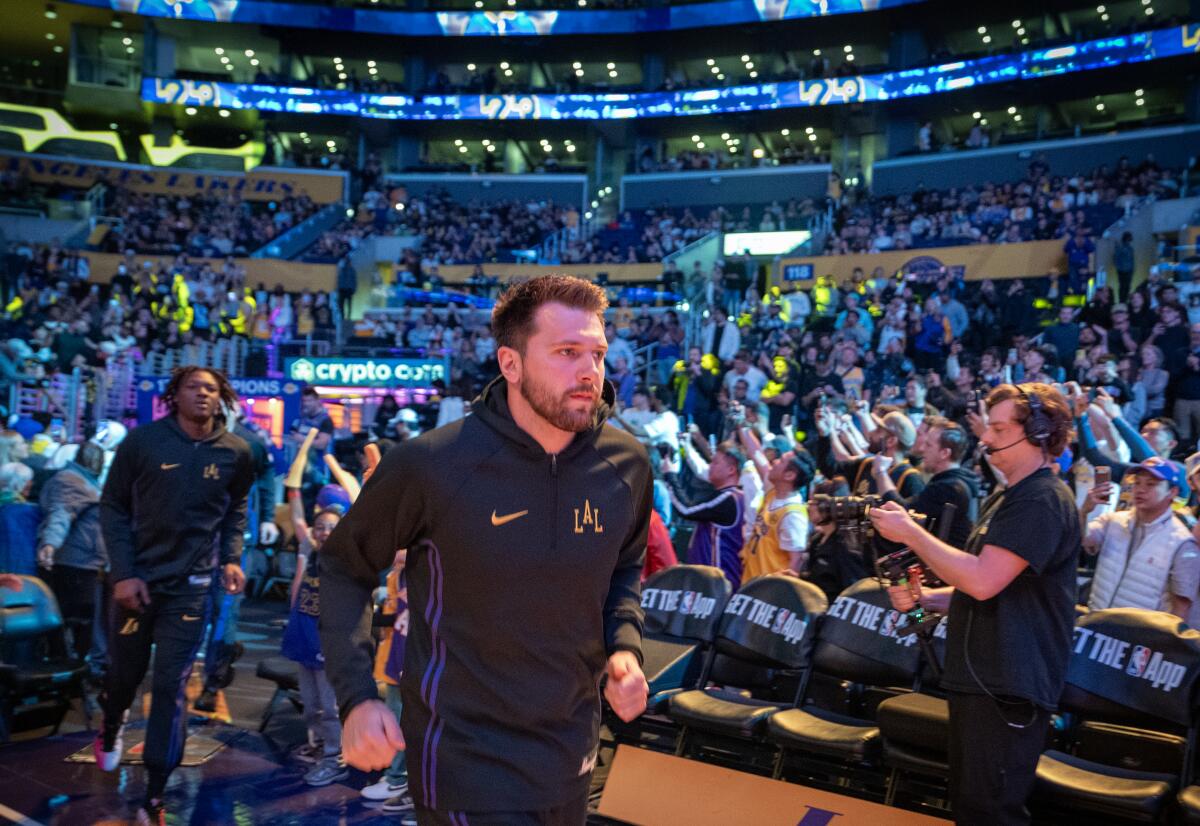 Lakers star Luka Doncic runs onto the court before a game against the Minnesota Timberwolves.