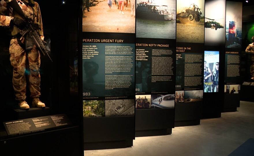 Displays showing SEALs in combat gear are shown along with panels with text and pictures depicting Navy SEAL history at the Navy SEAL Museum San Diego on March 23, 2026.