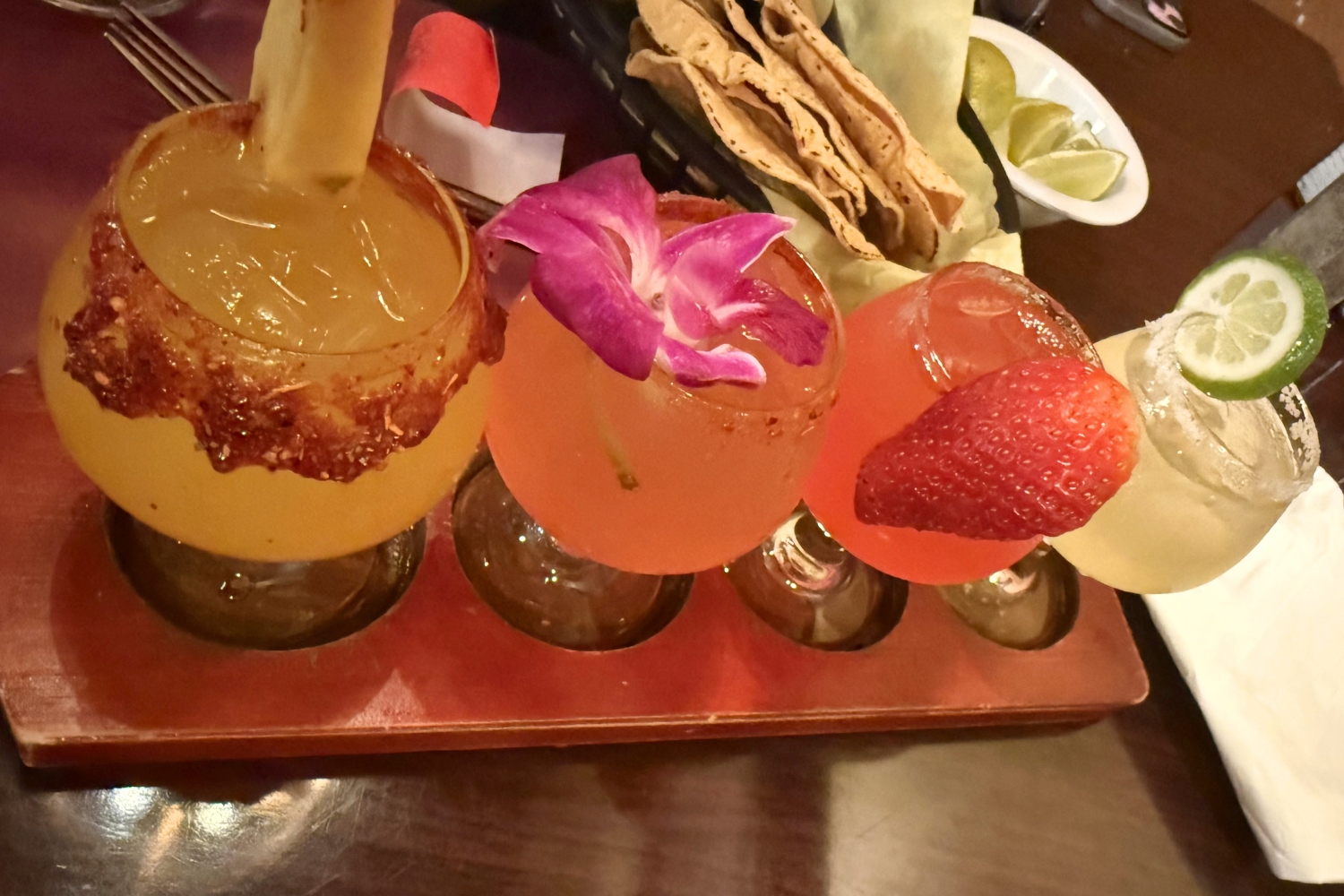 A margarita flight featuring watermelon, strawberry, mango, and lime margaritas....
