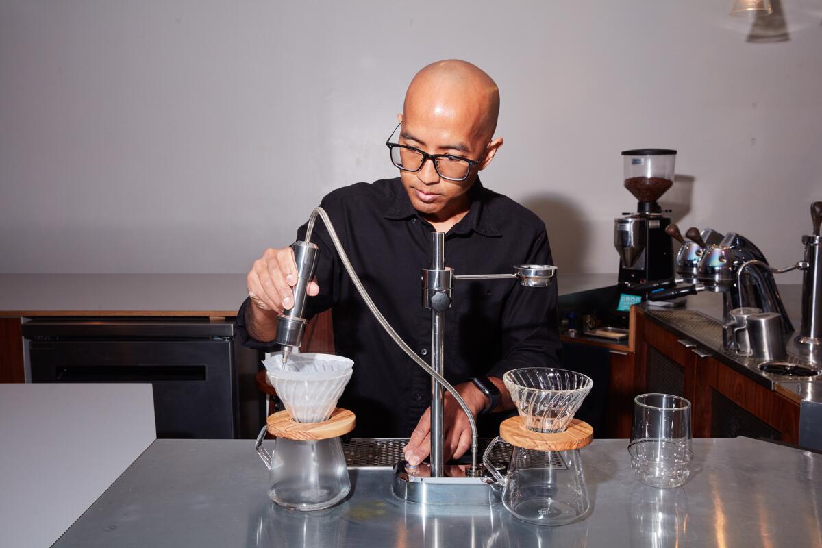 Endorffeine owner Jack Benchakul tests his drip coffee set up.