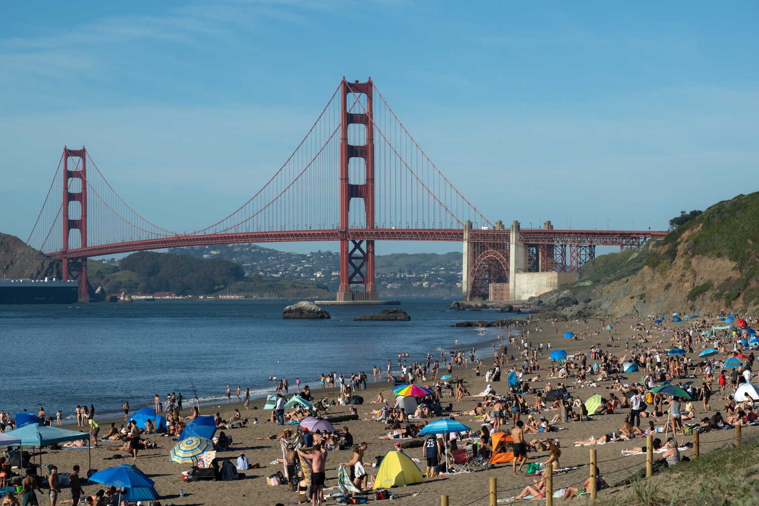 Sunbathers at Baker Beach, with the Golden Gate Bridge in the background.