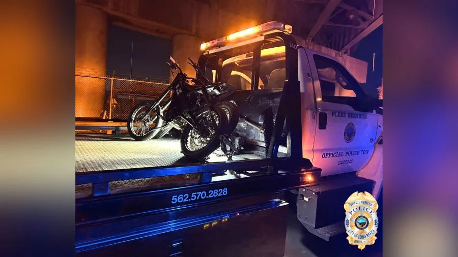 Electric motorcycles and a pocket bike secured on Long Beach police tow trucks following enforcement involving about 50 riders.