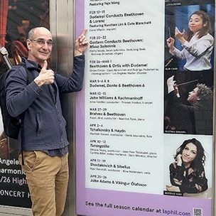 Ricardo Lorenz points to his name on the poster outside the LA Philharmonic.