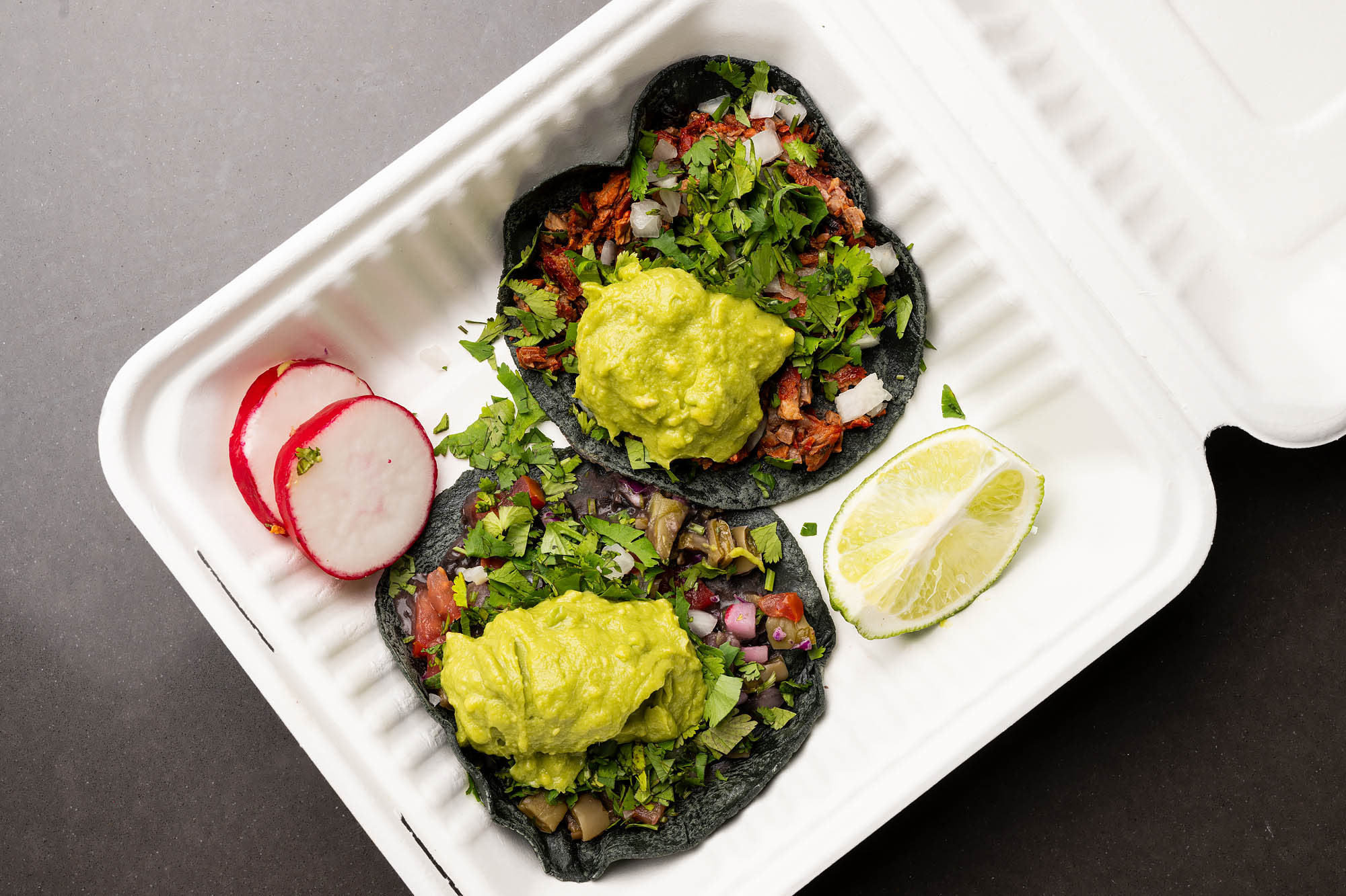 Chicken tacos on blue corn tortillas with salsa, radishes and lime at Villa’s Tacos Grand Central Market in Los Angeles.