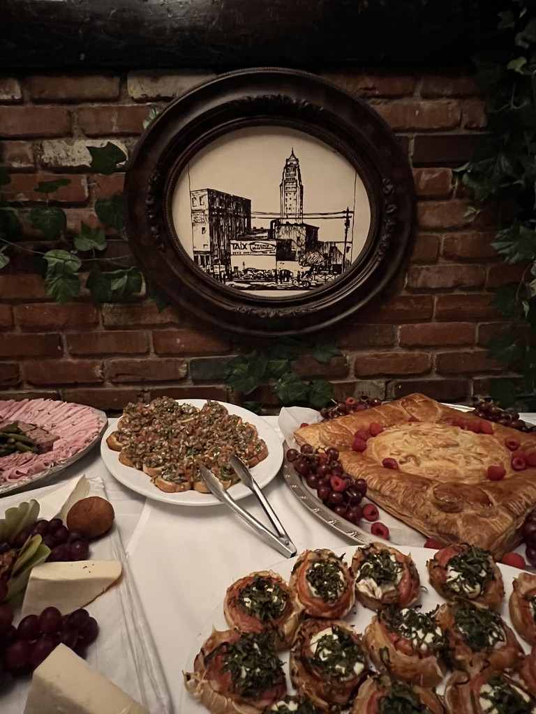 Spread of food on a white tablecloth-topped table at Taix.