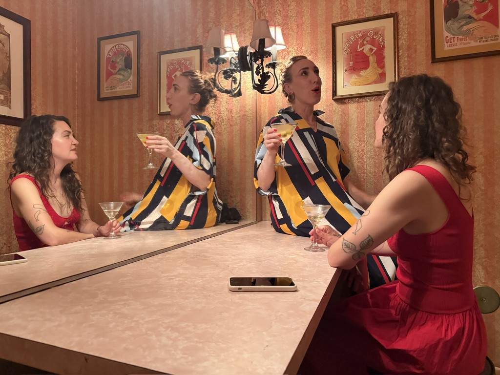 Megan Auster-Rosen and Sarah Rebecca Kessler sitting on the counter at the powder room at Taix.
