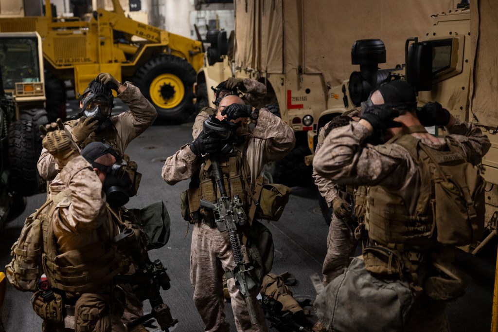 U.S. Marines don M50 joint service general purpose masks during training aboard USS Boxer.