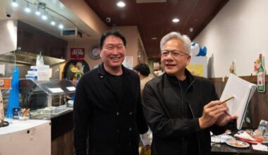 Nvidia CEO Jensen Huang shows his new book,