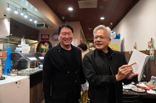 Nvidia CEO Jensen Huang shows his new book,