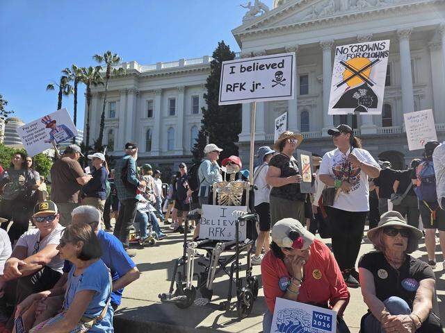 Hundreds of demonstrators stand at the Capitol building in Sacramento on Saturday morning before the start of the “No Kings” rally protesting the Trump administration.