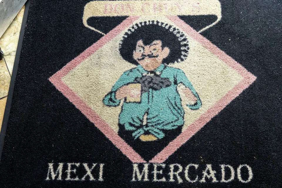 The doormat at the entrance of Don Chuy's Mexi-Mercado, a corner store in the Excelsior District of San Francisco, on Feb. 25, 2026. (Douglas Zimmerman/SFGATE)
