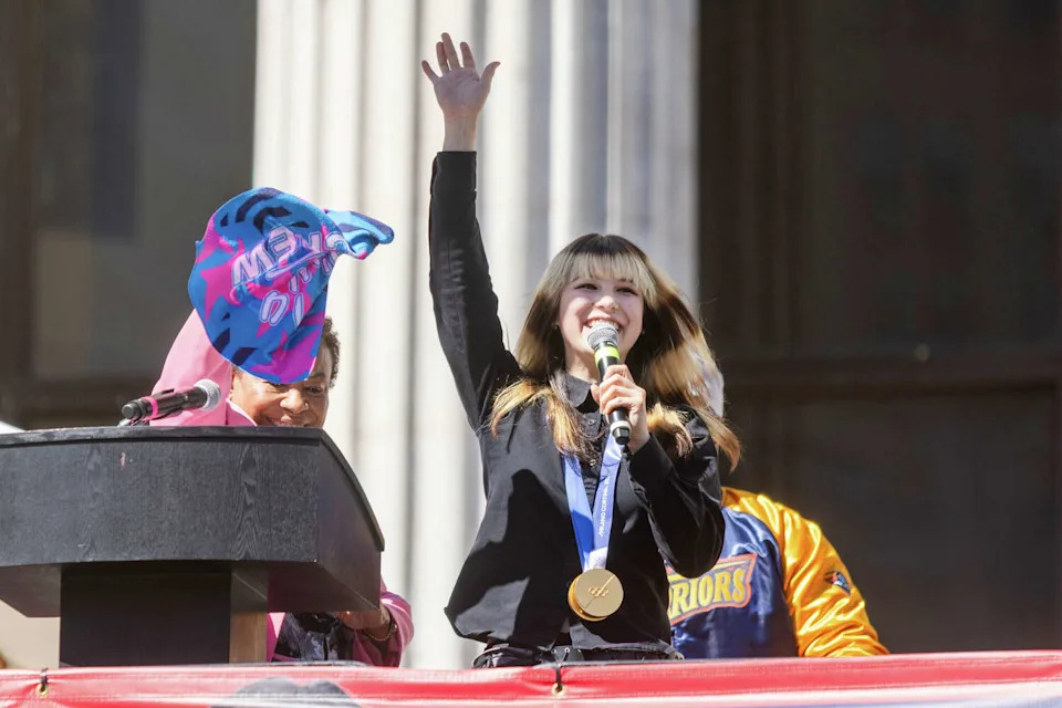 Olympic Figure Skating Gold Medalist Alysa Liu waves to the crowd during the Alysa Liu Celebration Rally at Frank Ogawa Plaza in front of City Hall in Oakland, California on March 12, 2026. (Douglas Zimmerman/SFGATE)