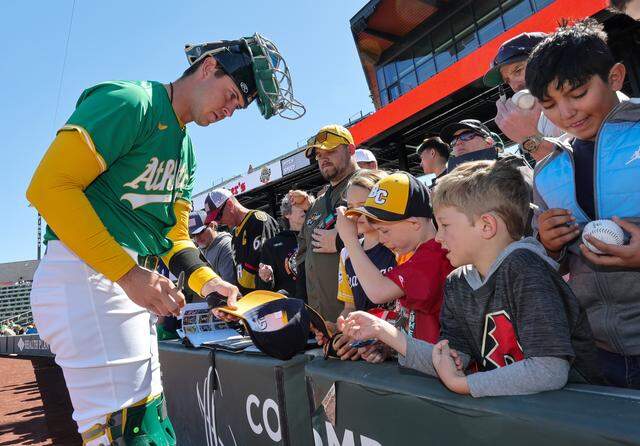 Daniel Susac of the Athletics signs autographs for fans before a spring training game against the Arizona Diamondbacks at Las Vegas Ballpark on March 9, 2025 in Las Vegas, Nevada. Susac was draftd in 2022 by the Athletics and will start the 2026 season on the San Francisco Giants 26-man roster.