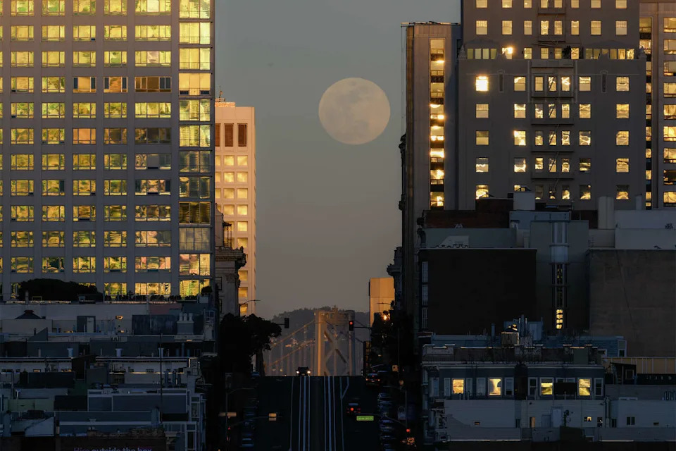 The full blood moon rises over California Street between buildings, as called "California Henge," in San Francisco on March 2, 2026. (Anadolu/Getty Images)