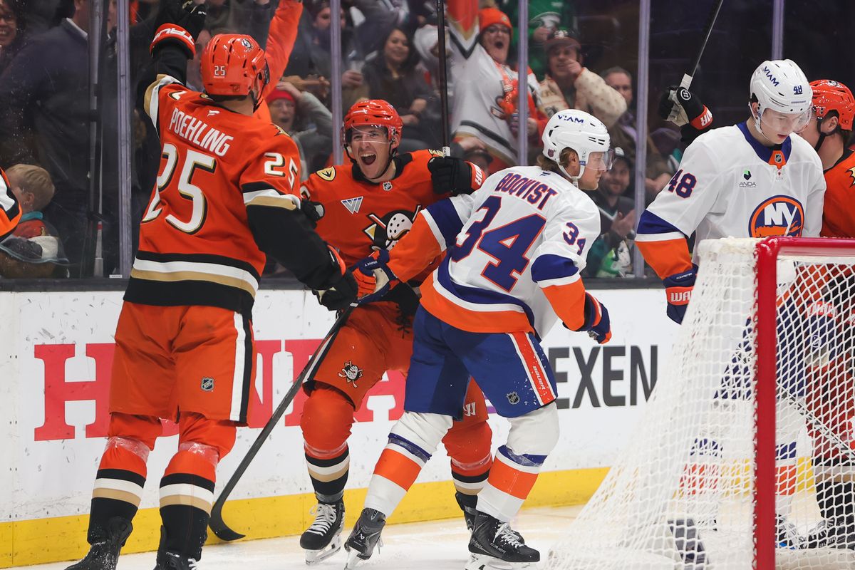 Anaheim Ducks center Ryan Poehling (25) celebrates a goal with a teammate during an NHL game against the New York Islanders on March 4, 2026 in Anaheim, CA.