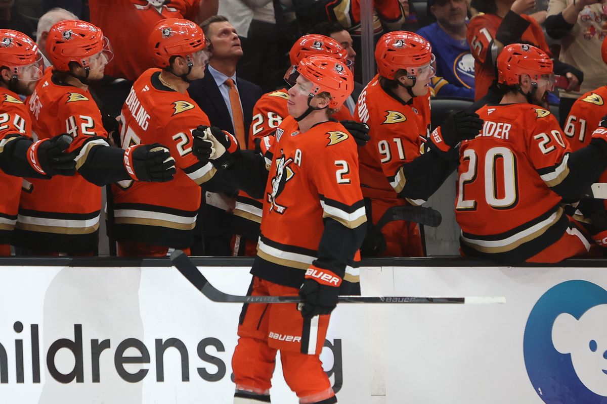 Anaheim Ducks defenseman Jackson LaCombe (2) celebrates scoring a goal with teammates during an NHL game against the Buffalo Sabres on March 22, 2026 in Anaheim, CA.