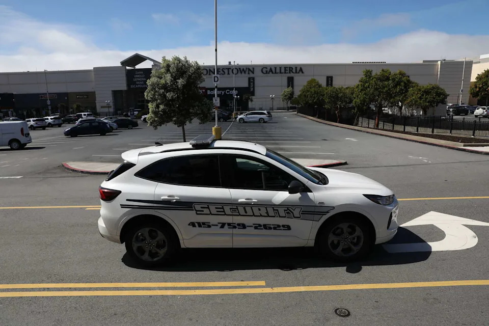 A security car is seen parked in the middle of 20th Ave. in front of Stonestown Galleria during an evacuation on Wednesday, March 25, 2026 in San Francisco. (Lea Suzuki/S.F. Chronicle)