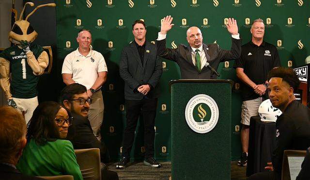 Sacramento State athletic director Mark Orr, center, excitedly announces Thursday, Sept. 26, 2024, plans for a new 25,000-seat, multi-use football stadium.