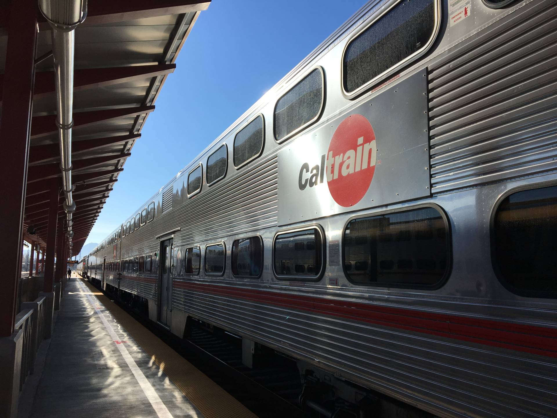 The side of a Caltrain train as it enters a station.