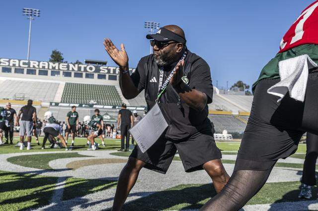 New Sacramento State football coach Alonzo Carter gives orders to his players during spring football drills on Thursday.
