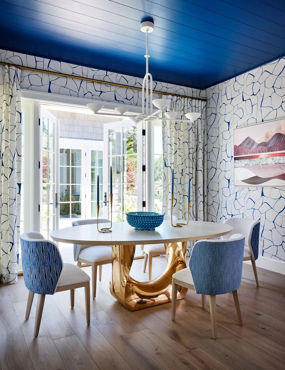 Contemporary dining area with unique table and vibrant decor.