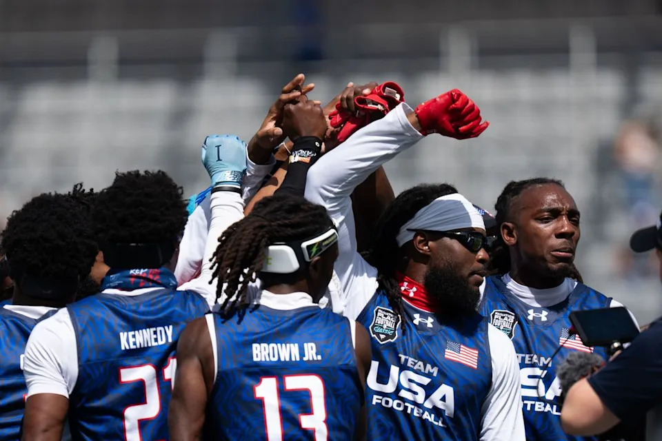 Team USA players huddle and prepare for the Fanatics Flag Football event, March 21, 2026, in Los Angeles.