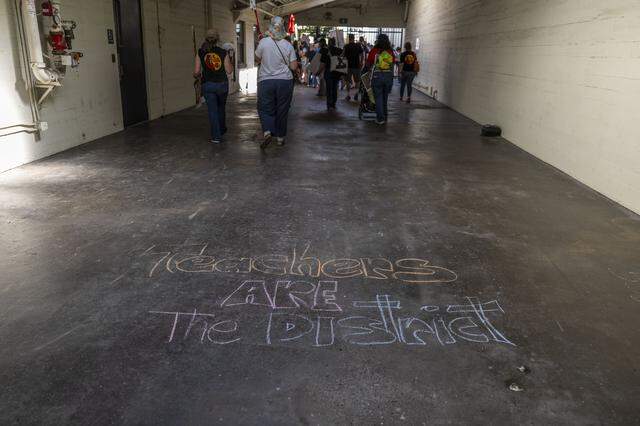 Twin Rivers Unified School District workers and students leave a hallway as they march at the district head quarters at McClellan Park on Thursday.