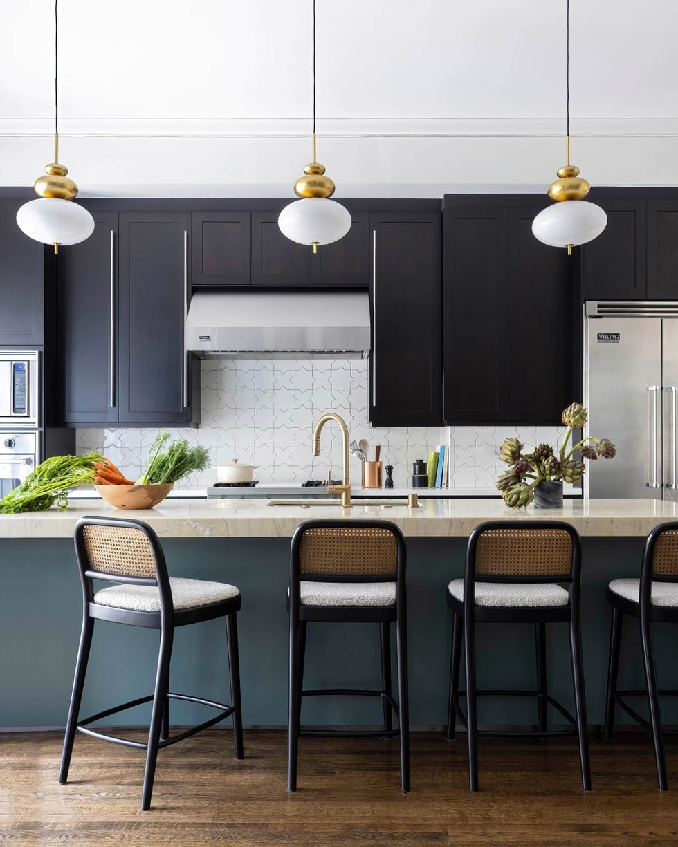 Modern kitchen with a bar counter and pendant lighting.