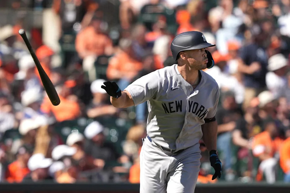 An image collage containing 1 images, Image 1 shows New York Yankees designated hitter Giancarlo Stanton tossing his bat after hitting a home run