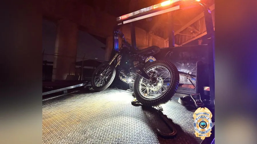 Electric motorcycles and a pocket bike secured on Long Beach police tow trucks following enforcement involving about 50 riders.