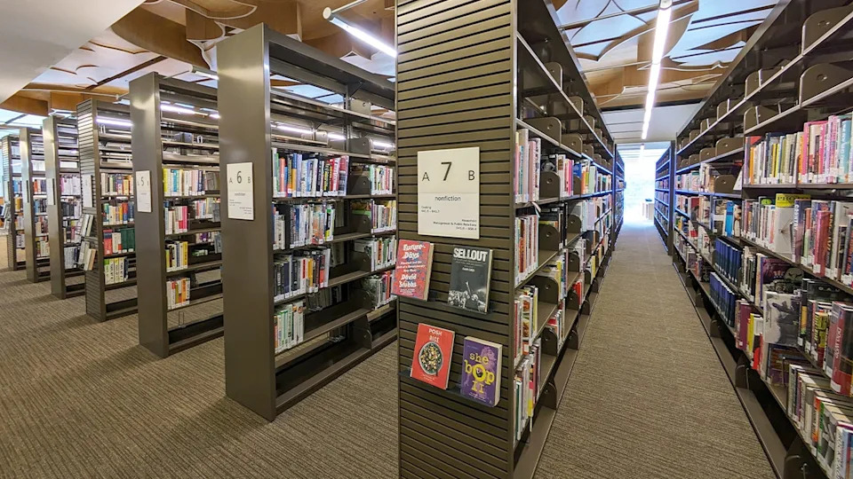 Shelves filled with nonfiction books inside the West Hollywood Library.