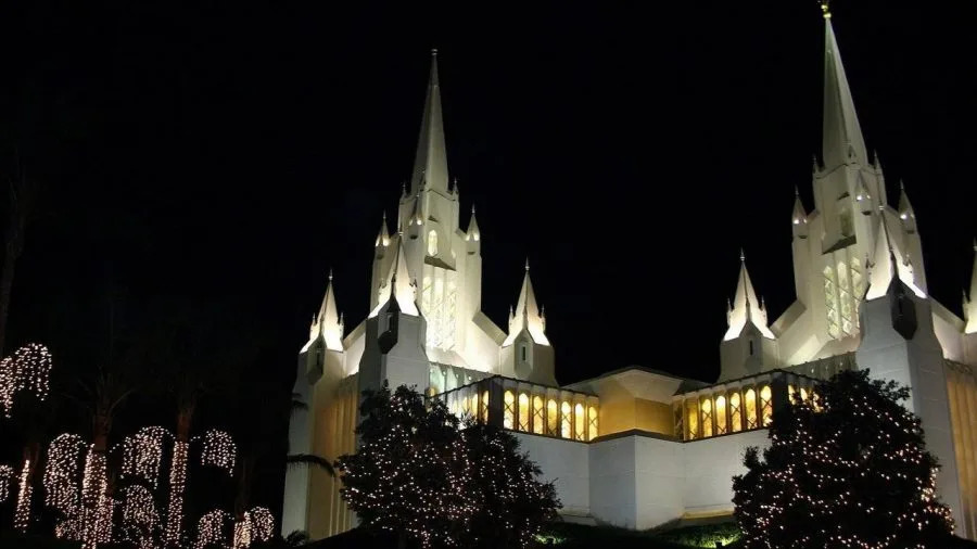 An LDS Church temple illuminated at night