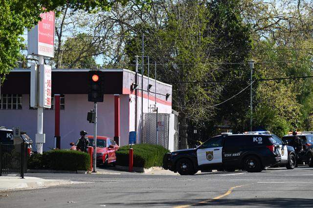 Sacramento Police officers respond to an incident at the Oak Park Market in south Oak Park on Thursday.