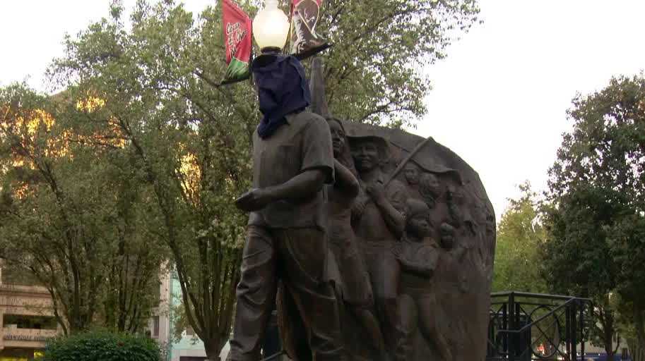 Sacramento city staff cover the head of César Chávez statue at plaza downtown