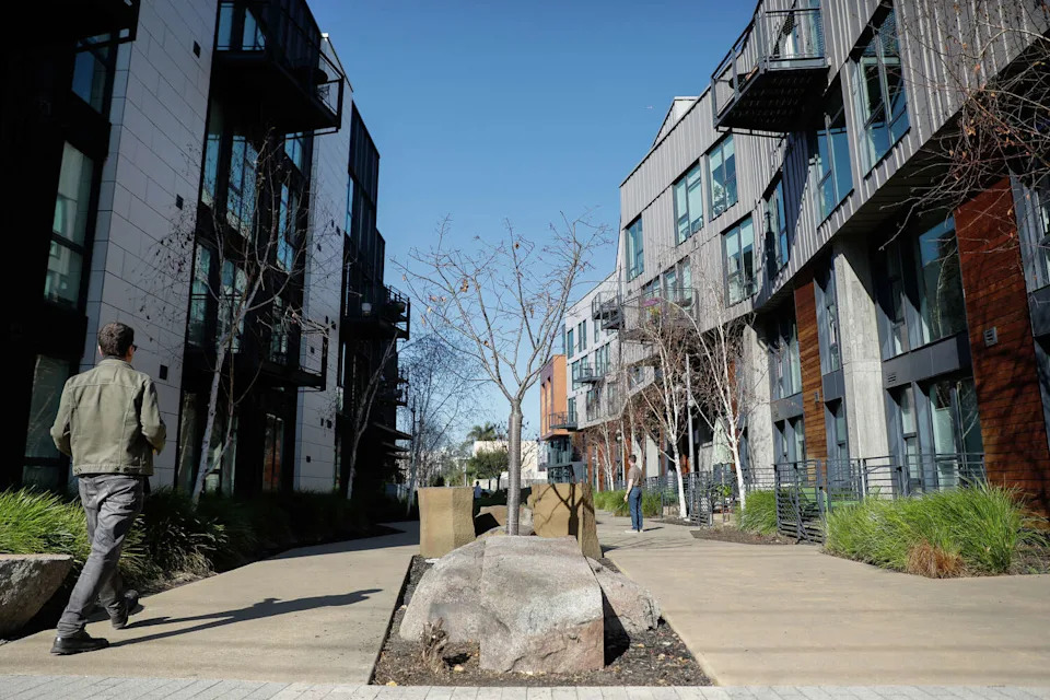 A pedestrian walk along a pathway at the central mews at Mason on Mariposa on Wednesday, February 4, 2026, in San Francisco. New developments in the Potrero Hill area have brought in younger residents. (Lea Suzuki/S.F. Chronicle)