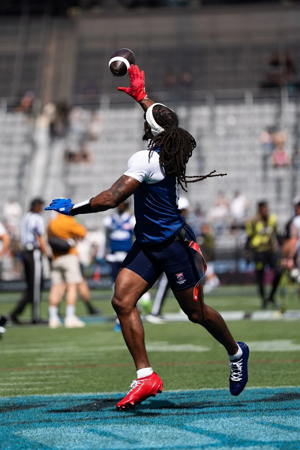 A Team USA player makes a one-handed catch during warmups ahead of the Fanatics Flag Football event, March 21, 2026, in Los Angeles.