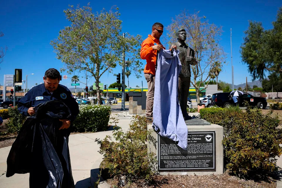 Public Works staff for the city of San Fernando cover the statue at the Cesar E. Chavez Memorial Park