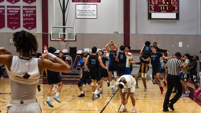 Natomas Nighthawks guard Alfred Wilkins slumps after his team was unable to score on its final possession and the Priory Panthers celebrate their 65-63 victory in the CIF Northern California Division III boys basketball regional semifinal on Saturday.